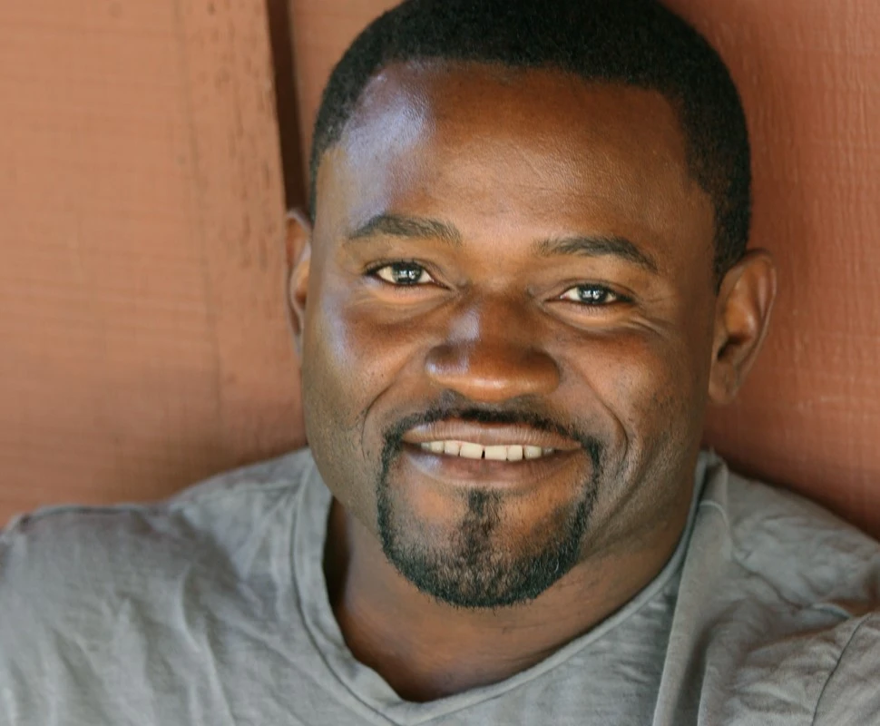 Ron Denson smiling, in a gray shirt